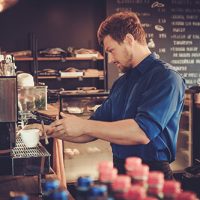 handsome-barista-preparing-cup-of-coffee-for-PDU87MM